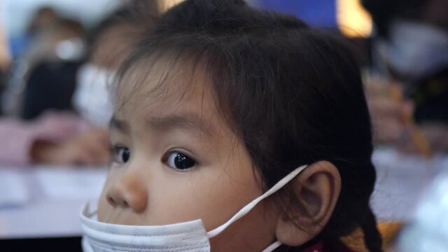 Slow Motion Scene Of A 5 Year Old Asian Girl Watching A Performance On Stage.