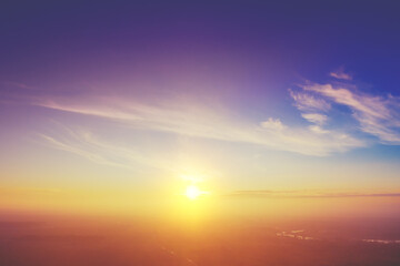 Colorful cloudy sky at sunset. Sky texture abstract nature background. Aerial view of the countryside in the foggy evening