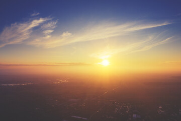 Colorful cloudy sky at sunset. Sky texture abstract nature background. Aerial view of the countryside in the foggy evening