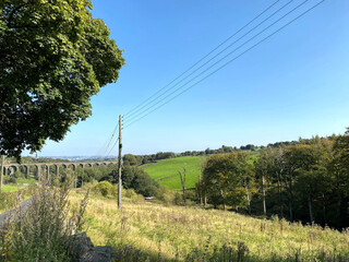 Obraz premium Looking down from, Alderscholes Lane, at the Thornton Viaduct, with hills and trees, in the distance in, Thornton, Bradford, UK