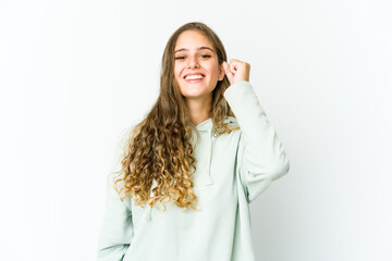 Young caucasian woman celebrating a victory, passion and enthusiasm, happy expression.