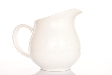 One white ceramic jug, close-up, isolated on white.