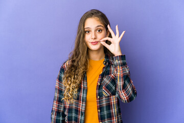 Young caucasian cute woman with fingers on lips keeping a secret.