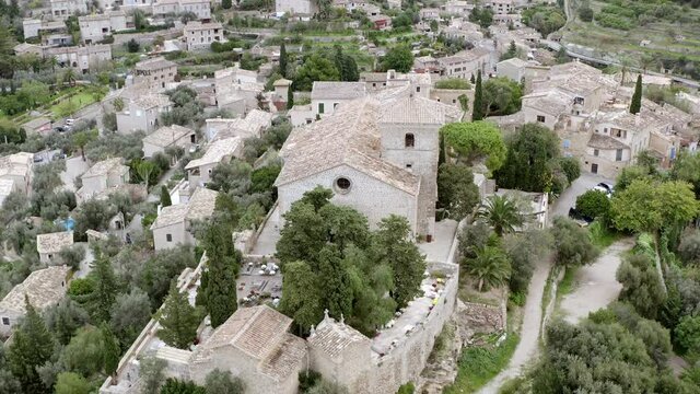 Architecture of European old village dron 4K video. Aerial view of a landscape with historic buildings and houses with tiled roofs on the streets where trees grow.