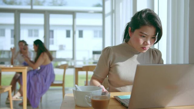 attractive asian female use laptop working online conference meeting social distancing new normal working lifestyle,asian woman working near big glass window morning time