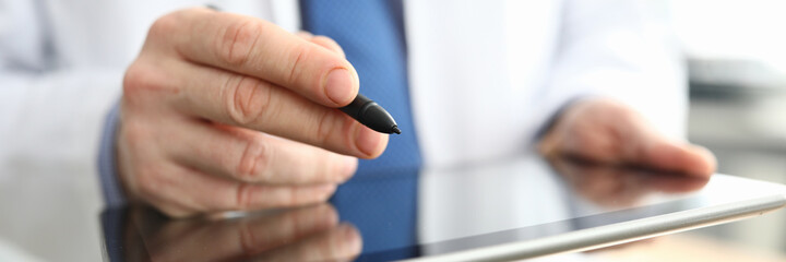 The doctor is holding a tablet and pen. Platform for an online consultation with doctors during a pandemic