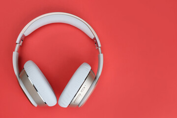 Full-size wireless overhead headphones on red background