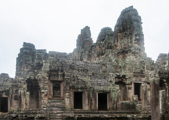 Naklejka premium Bayon the central temple of Angkor Thom, late 12th century. It rains in the rainy season. (Cambodia, 04.10. 2019)