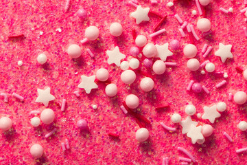 Sugar confetti on a shiny background. Abstract pink holiday background