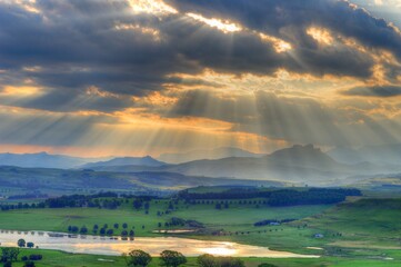 SUNBEAMS, CLOUDS AND MOUNTAINS.  Sunset in the southern Drakensberg, Underberg, kwazulu Natal, South Africa