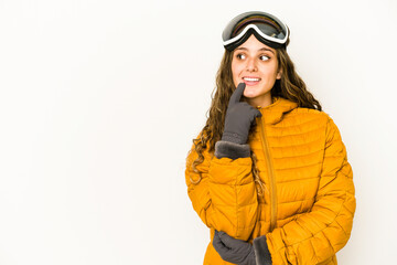 Young caucasian snowboarder woman isolated relaxed thinking about something looking at a copy space.