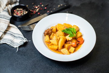 goulash meat with potatoes stewed vegetables and pork on the table for healthy meal snack outdoor...