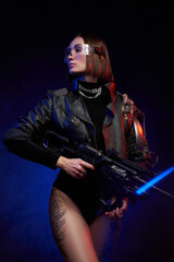 Fototapeta na wymiar Fantasy portrait of a martial woman dressed in stylish black clothing and holding futuristic rifle. Female mercenary in cyberpunk style posing in dark and colourful background.