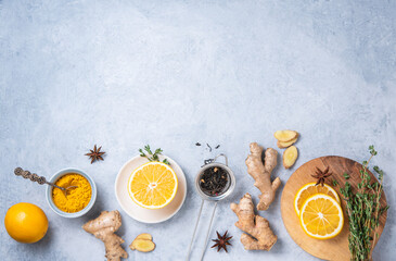 Immune boosting remedy. Flat lay  with ingredients for anti-virus drink from turmeric, thyme, lemon and  star anise on blue background