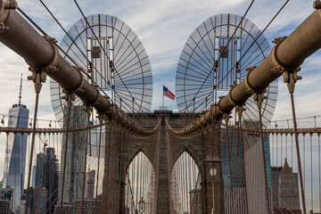 Brooklyn Bridge New York, with the flag of the USA blowing