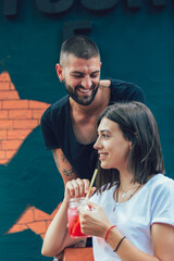 Beautiful loving couple sitting in a cafe drinking coffee and enjoying in conversation.