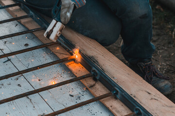 A man welds a metal frame to build an aviary, welding metal close up.
