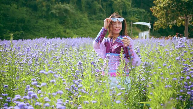 attractive asian female woman casual cloth walking relax leisure hand touch purple flower filed style with a bouquet of lavender in a bouquet of a bouquet of many flowers scoop summer purple field