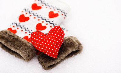 Red shape of heart and mittens on the snow, Valentines background with copy space. Greeting card, banner