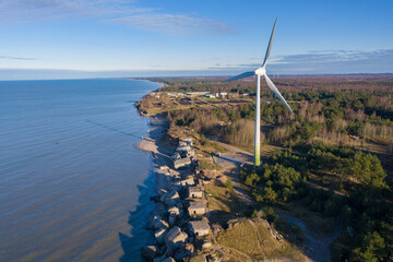 Aerial view of Liepaja Northern Forts, old abandoned fortifications at Baltic sea coast in Latvia. Large wind turbine