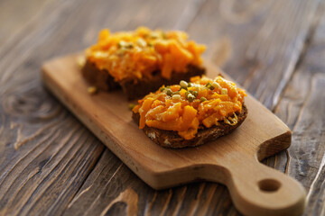Delicious baked pumpkin sandwiches with cheese, sesame seeds and sprouted beans