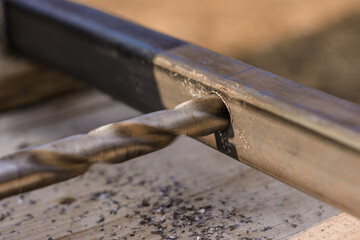 Metal drilling close up, electric drill and metal.