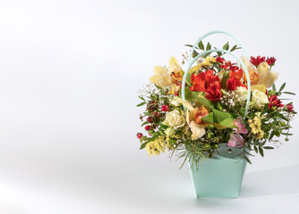 Delicate orchids in a gift box or basket on a light background. Space for text. Bouquet of orchids, roses and chrysanthemums. Festive postcard.