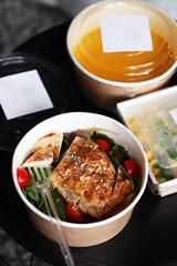 Lunch boxes with food ready for work or school, pre-cooking or diet. Pumpkin soup and baked chicken with tomatoes. Healthy food delivery.