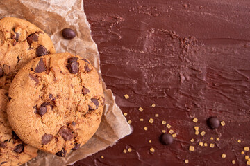 dark chocolate chip cookie round gold concept Organic fresh bake homemade tasty sweet dessert piece of closeup on cookie on wooden table for holiday new year Christmas gift sugar sparkle