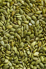 Close-up background texture of green pumpkin seeds.