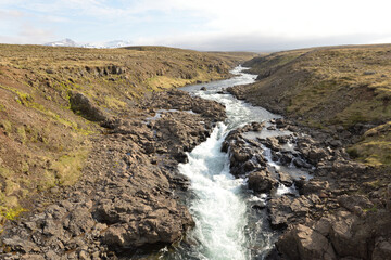 Stream flowing through lava field in Iceland