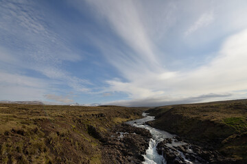 Fototapeta na wymiar Stream flowing through lava field in Iceland