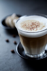 Coffee with milk on dark stone background. Close up.	