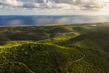 Aerial view above scenery of Curacao, Caribbean with ocean, coast, hills, lake