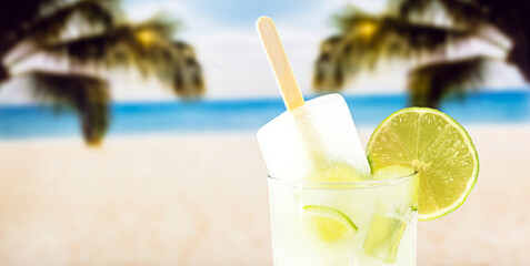 lemon drink with popsicle, beach in the background. Drink known as caipirinha in brazil, ice cream with alcohol and lemon