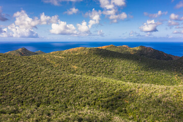 Aerial view above scenery of Curacao, Caribbean with ocean, coast, hills, lake