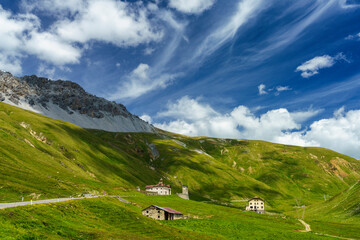Fototapeta na wymiar Iridescent cloud over the road to Stelvio pass (Lombardy) at summer