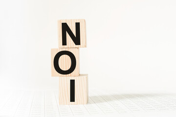 a word NOI on wooden cubes. business concept. business and Finance