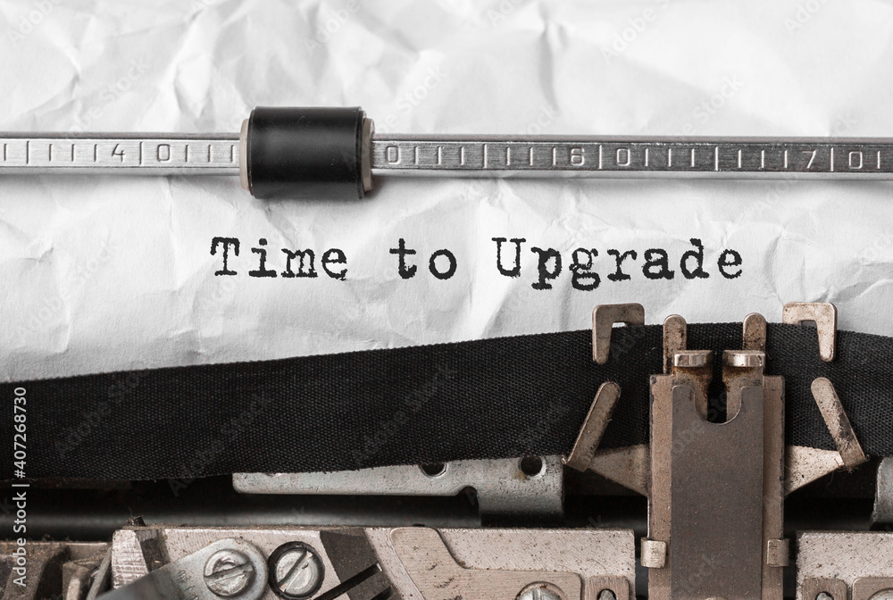 Poster text time to upgrade typed on retro typewriter