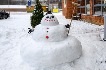 Snowman on street in the city. Winter season