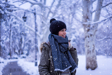 Beautiful happy female in the winter walk outdoors with a lot of snow