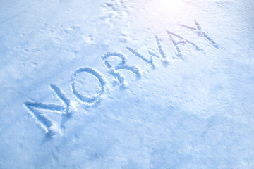 Text Norway written on the snow surface.