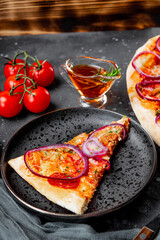 A piece of classic Italian pepperoni pizza with onion on a plate