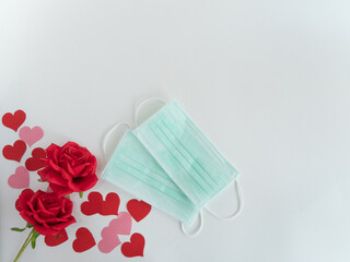 Surgical mask in new normal (covid-19 period) creative valentine’s day concept with hearts and roses
