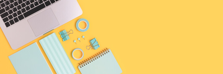 Banner with laptop and office supplies on a yellow background. E-learning concept with copy space....