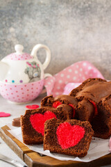 St. Valentine's Day, Mother's Day or Birthday festive dessert. Homemade sweet chocolate brownie with hearts for Valentine's Day on a stone countertop. Copy space.