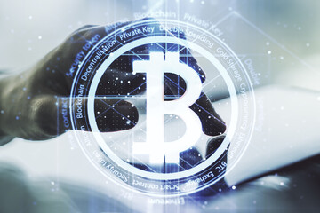 Double exposure of creative Bitcoin symbol with finger clicks on a digital tablet on background. Cryptocurrency concept