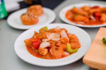 Kid using chopsticks to pick up shrimps isolated on a white background. Healthy eating lifestyle concept.