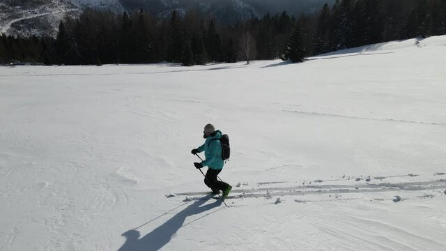 Ski touring adventure in Beskidy Mountains, Poland. Man backcountry skiing in fresh powder snow.