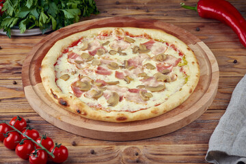 Pizza with meat, vegetables and mushrooms, wooden background